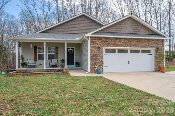 a view of a house with a yard and sitting area