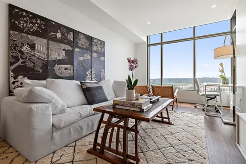 a living room with furniture and floor to ceiling window