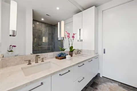 a bathroom with a sink double vanity and a mirror