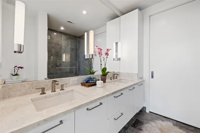 a bathroom with a sink double vanity and a mirror