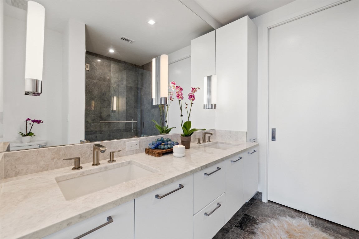 501 West Avenue, Unit 2202 Austin, TX 78701 - Photo 19 of 33 a bathroom with a sink double vanity and a mirror