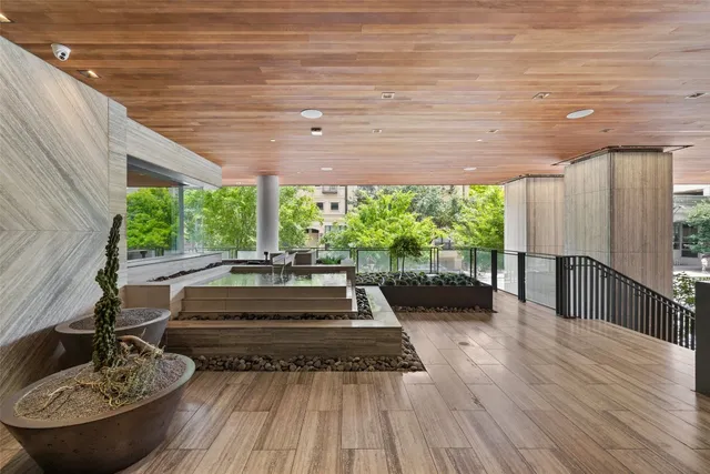 a view of a patio with table and chairs potted plants with wooden floor