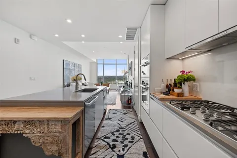 a kitchen with stove a sink and a counter top space