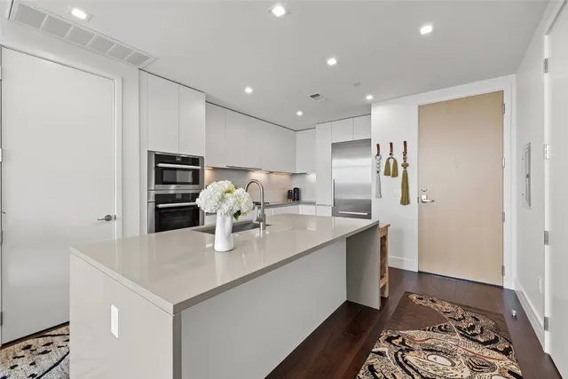 a kitchen with stainless steel appliances a sink and stove