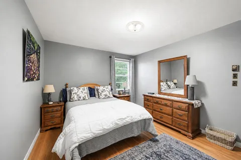 a bedroom with a bed and a dresser in it