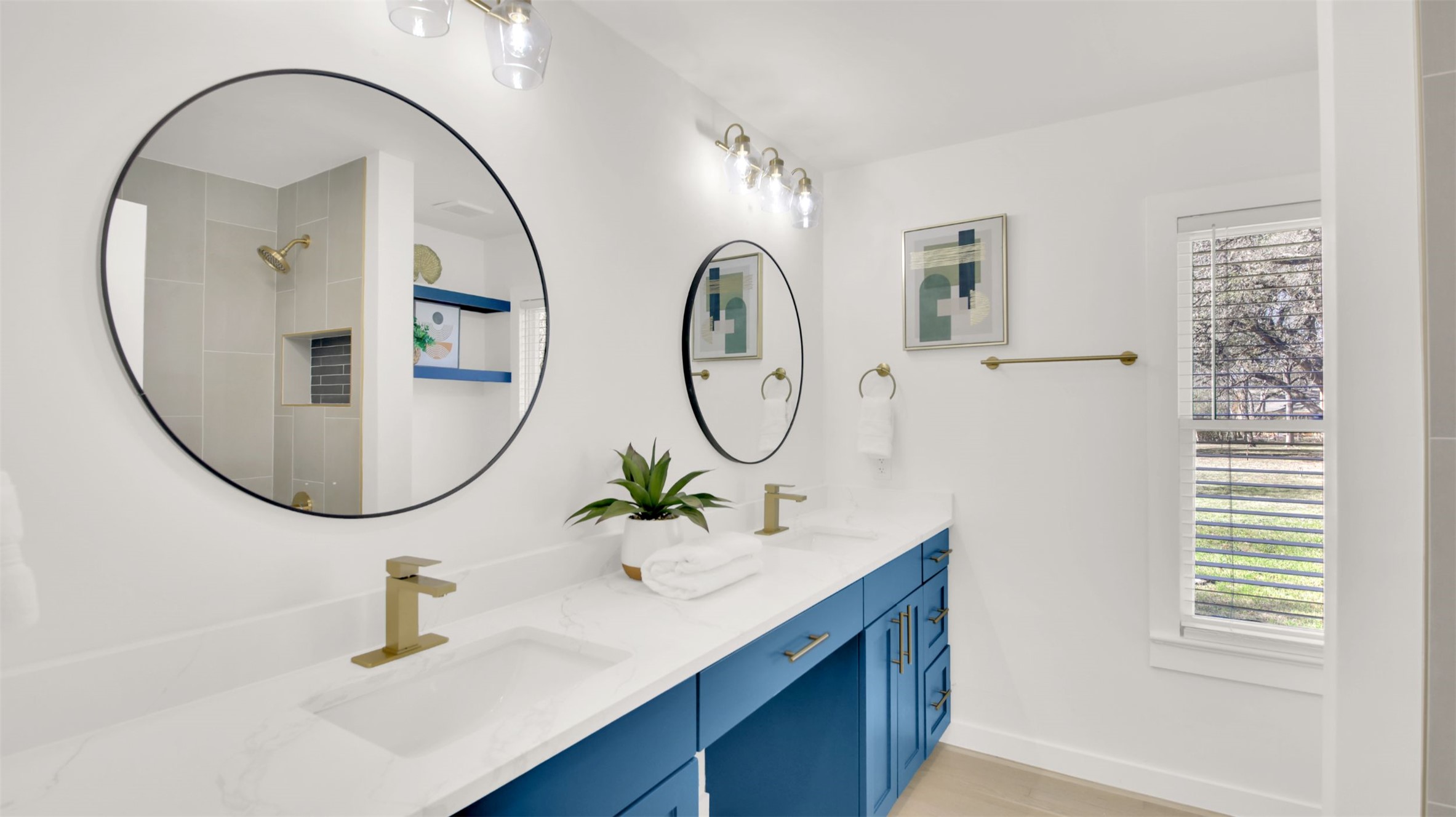 8904 Chisholm Lane Austin, TX 78748 - Photo 12 of 36 Bathroom with double vanity, a shower, and light wood-type flooring