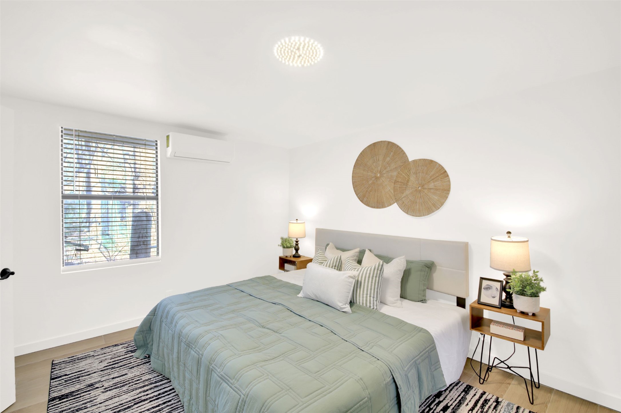 8904 Chisholm Lane Austin, TX 78748 - Photo 20 of 36 Bedroom featuring an AC wall unit and light wood-style flooring