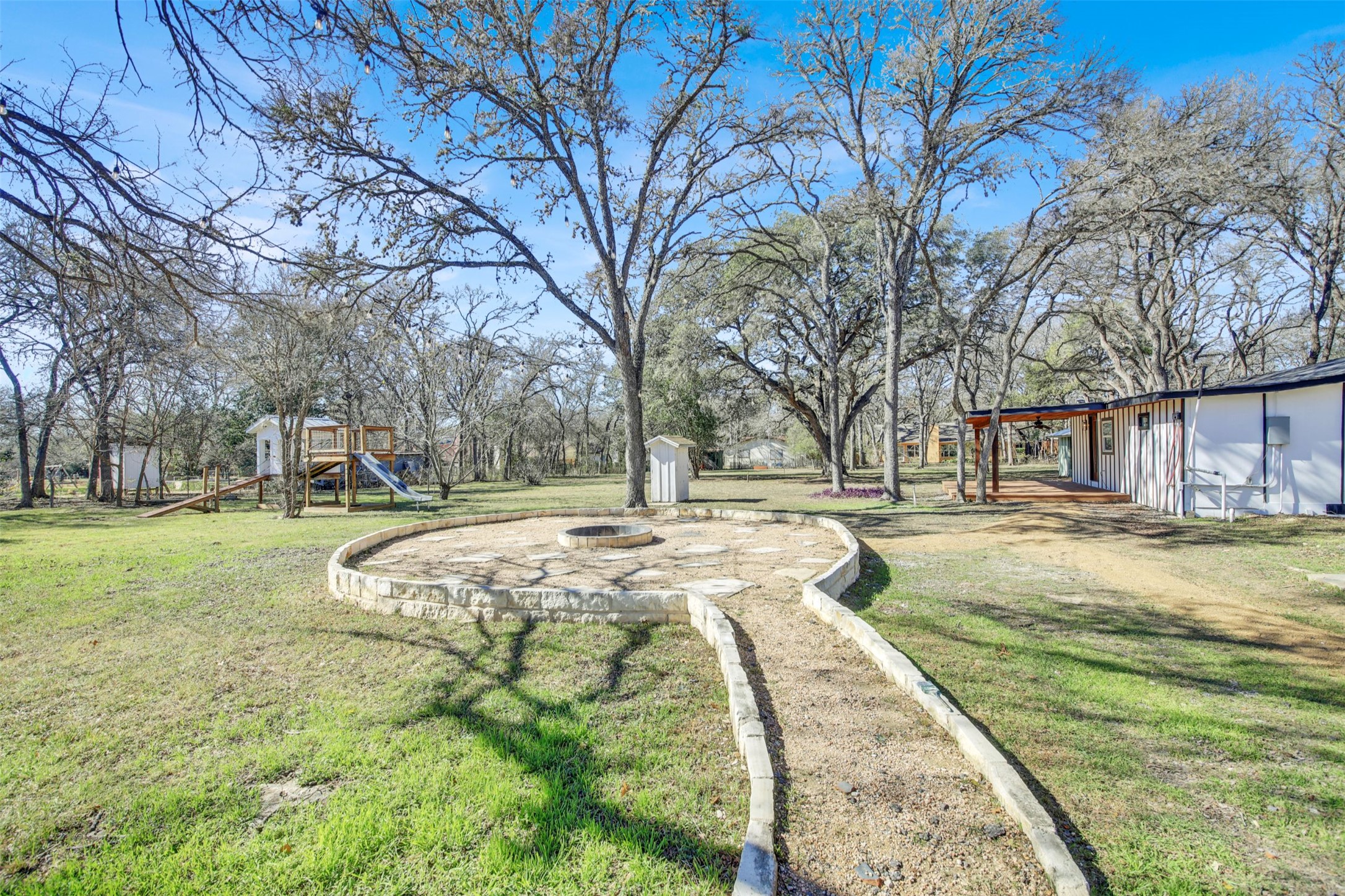 8904 Chisholm Lane Austin, TX 78748 - Photo 32 of 40 View of green lawn featuring a playground and a storage unit