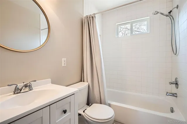 a bathroom with a sink toilet and a mirror