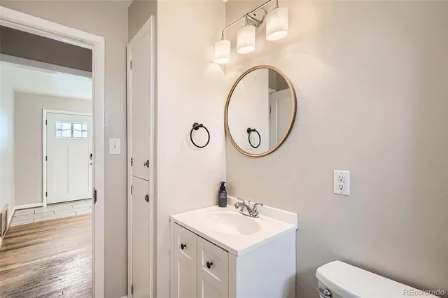 a bathroom with a toilet a sink and a mirror
