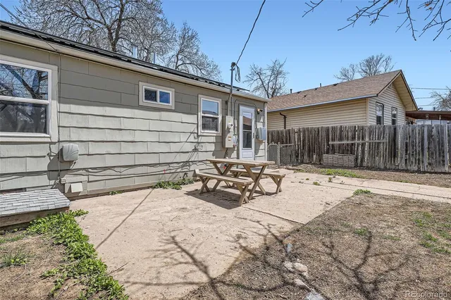 a view of backyard of house with outdoor seating and covered with snow