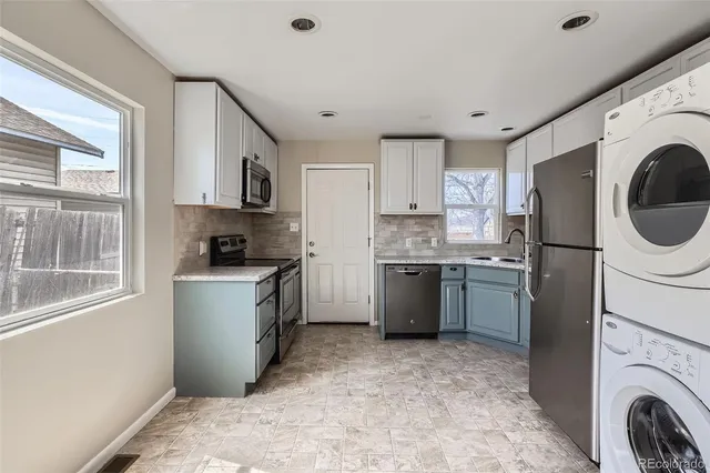a kitchen with a refrigerator sink and cabinets