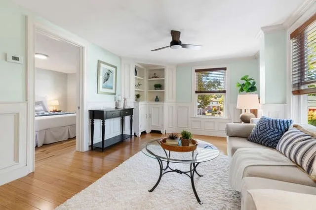 a living room with furniture and a wooden floor