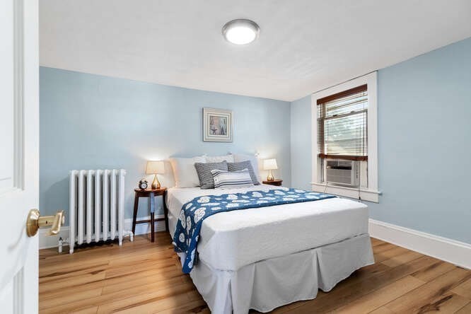 44 Cherry Street, Unit 2 Swampscott, MA 01907 - Photo 13 of 36 a bedroom with a bed and wooden floor