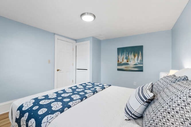 44 Cherry Street, Unit 2 Swampscott, MA 01907 - Photo 16 of 36 a bedroom with a bed and a painting on the wall