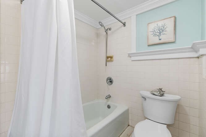 44 Cherry Street, Unit 2 Swampscott, MA 01907 - Photo 22 of 36 a white toilet sitting next to a bath tub