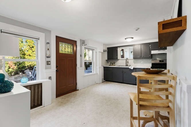 44 Cherry Street, Unit 2 Swampscott, MA 01907 - Photo 6 of 36 a kitchen with stainless steel appliances kitchen island granite countertop a refrigerator and a stove top oven