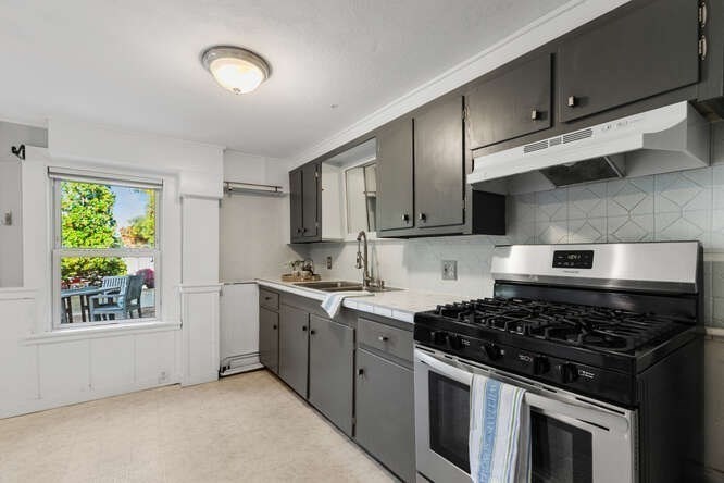 44 Cherry Street, Unit 2 Swampscott, MA 01907 - Photo 9 of 36 a kitchen with stainless steel appliances granite countertop a stove and a sink