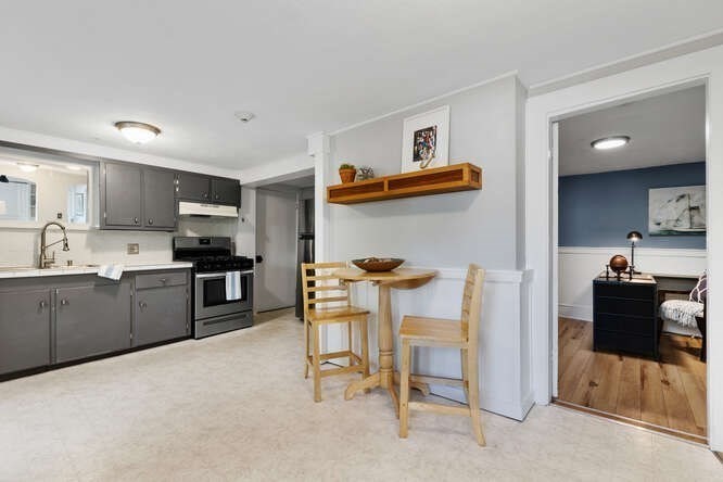 44 Cherry Street, Unit 2 Swampscott, MA 01907 - Photo 10 of 36 a kitchen with stainless steel appliances kitchen island granite countertop a refrigerator and a stove top oven