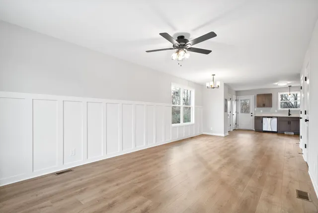 a view of a livingroom with a ceiling fan and window
