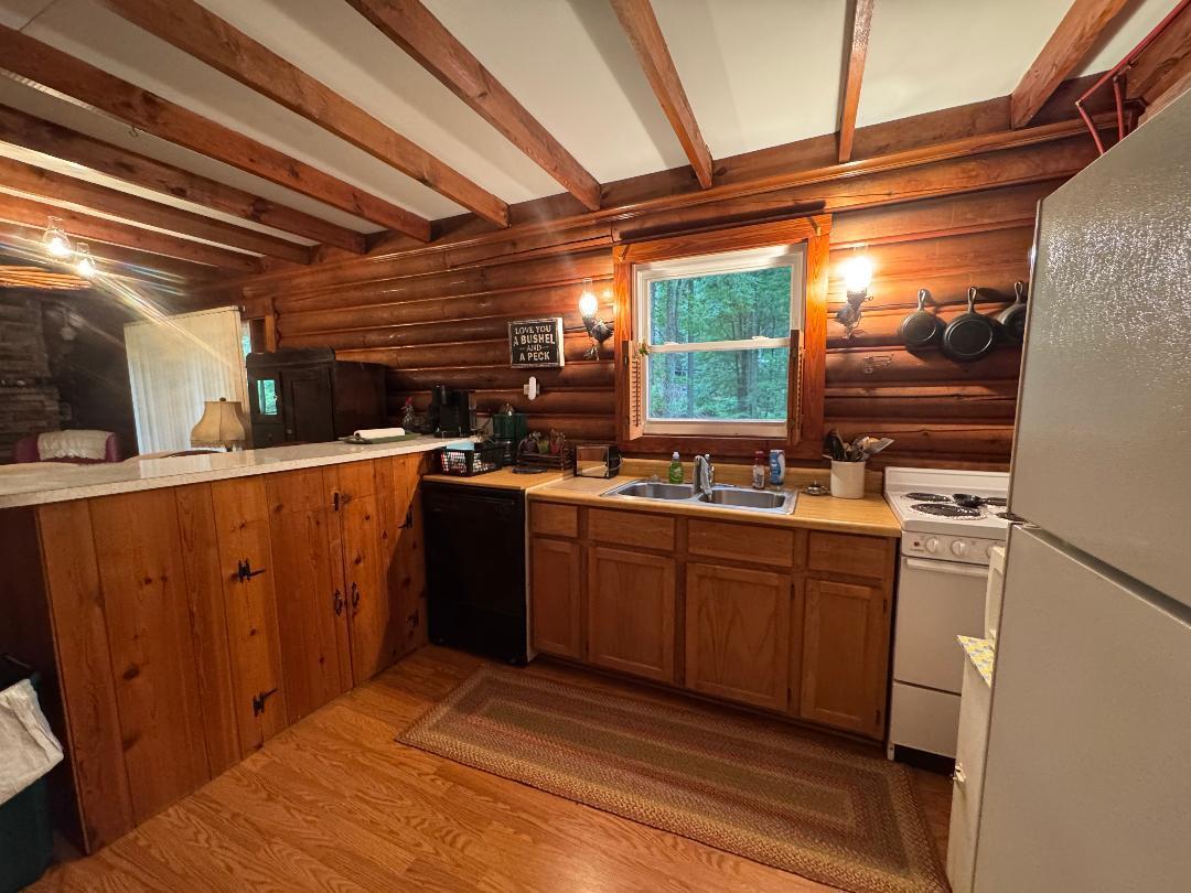 388 Salt House Branch Road Henry, VA 24102 - Photo 23 of 42 a kitchen with a sink appliances cabinets and a large window