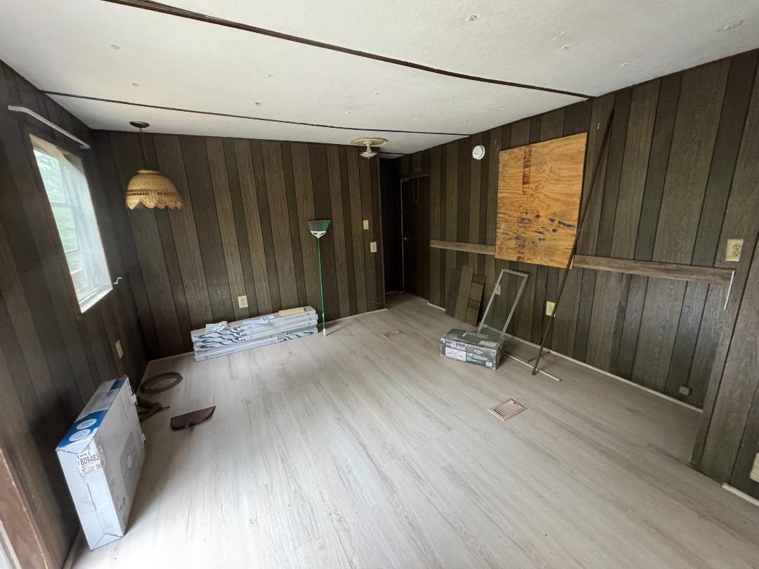 388 Salt House Branch Road Henry, VA 24102 - Photo 35 of 42 a room with a mirror and a wooden floor