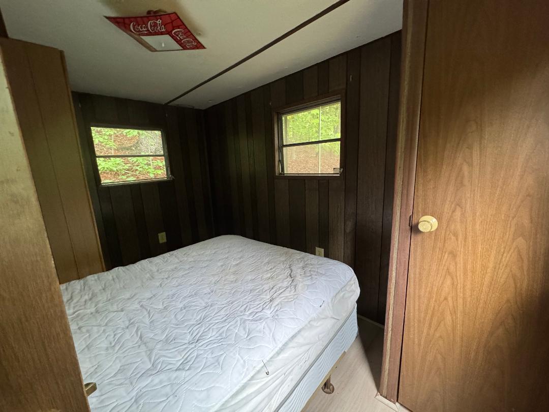 388 Salt House Branch Road Henry, VA 24102 - Photo 36 of 42 a bedroom with a bed and a tv