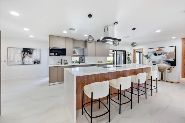 a kitchen with stainless steel appliances kitchen island granite countertop a sink and cabinets