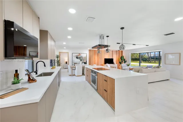 a large kitchen with stainless steel appliances lots of counter top space