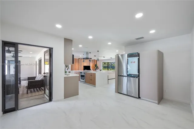 a view of kitchen with furniture and refrigerator