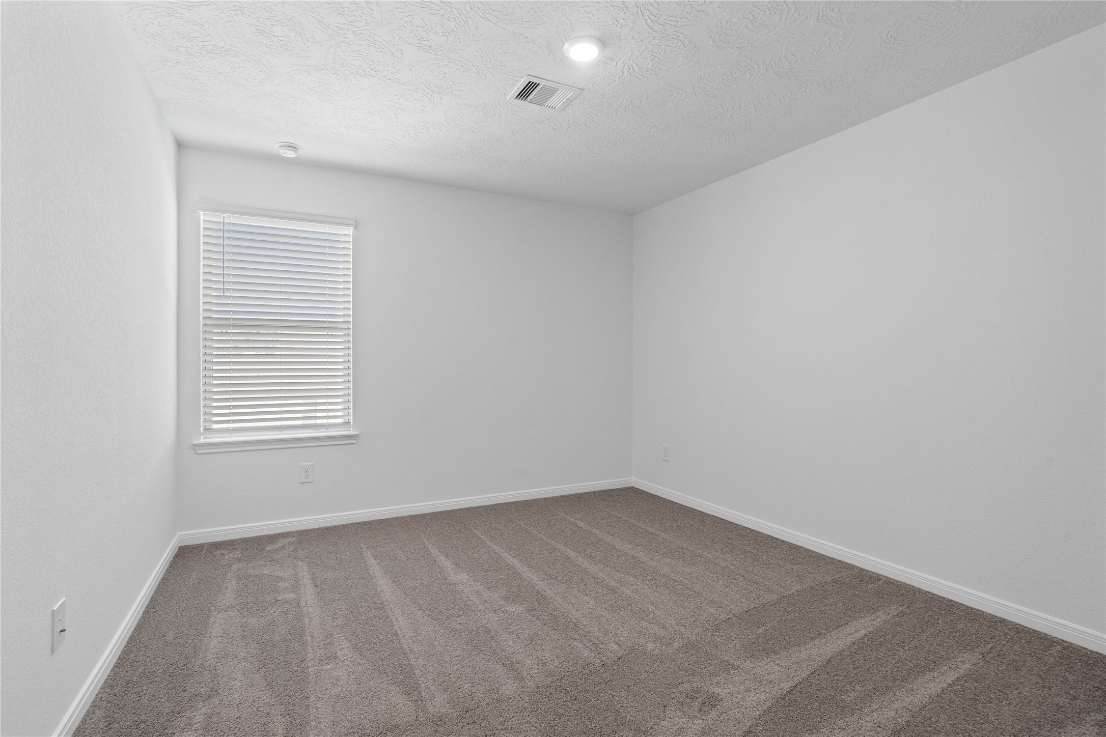 25503 Alpine Switchback Drive Spring, TX 77373 - Photo 24 of 32 This secondary bedroom offers comfort and style with plush carpeting, neutral paint tones, recessed lighting, large window with blinds, and closet.