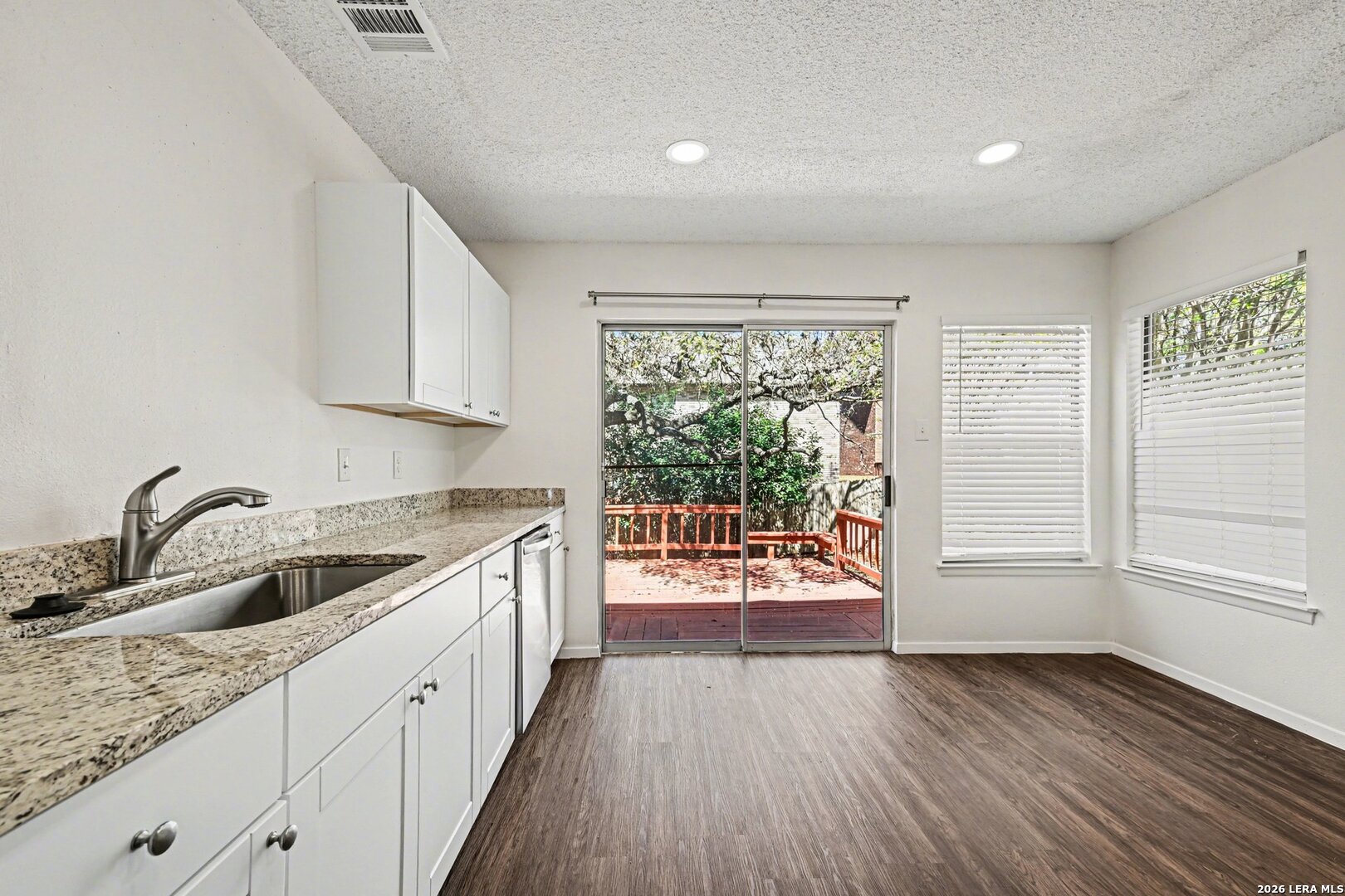 2407 Canyon Rim San Antonio, TX 78232 - Photo 13 of 30 a kitchen that has a sink and a wooden floor