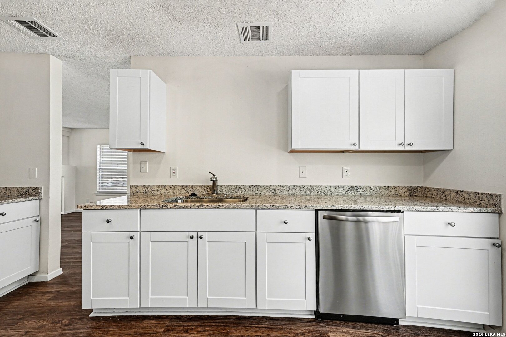2407 Canyon Rim San Antonio, TX 78232 - Photo 14 of 30 a kitchen with granite countertop white cabinets and sink
