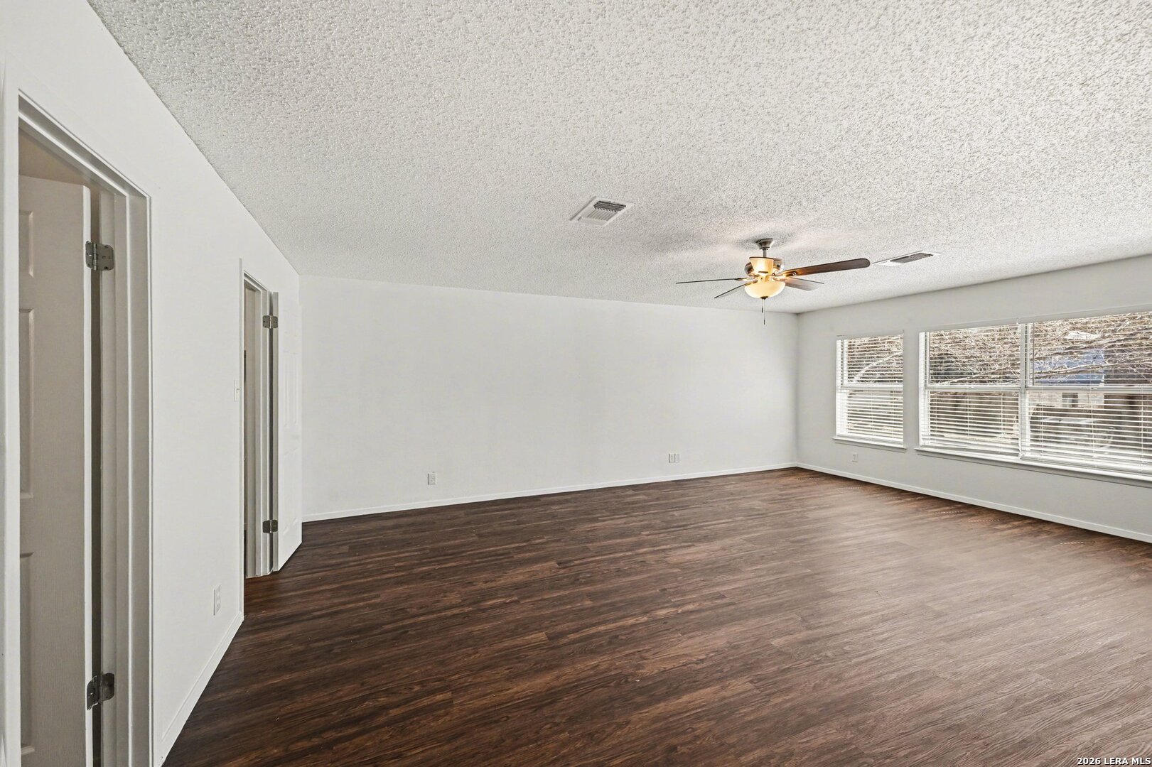 2407 Canyon Rim San Antonio, TX 78232 - Photo 17 of 30 a view of an empty room with wooden floor and a window