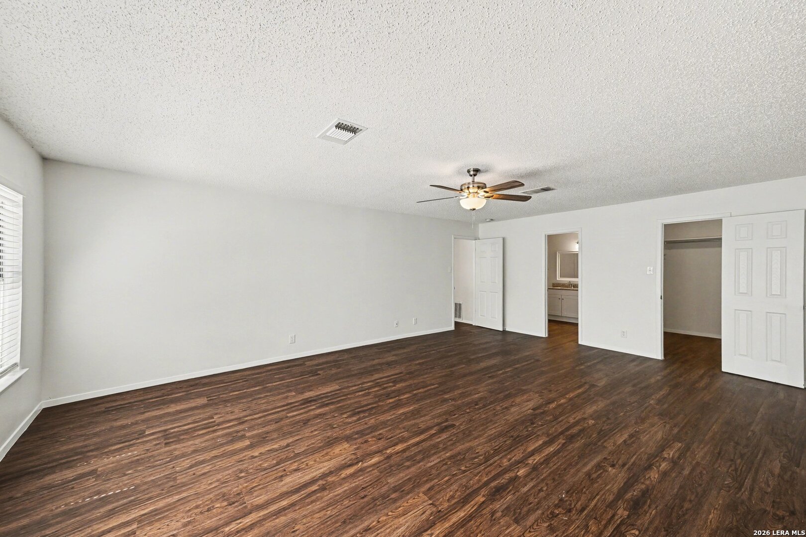 2407 Canyon Rim San Antonio, TX 78232 - Photo 19 of 30 a view of empty room with wooden floor and ceiling fan