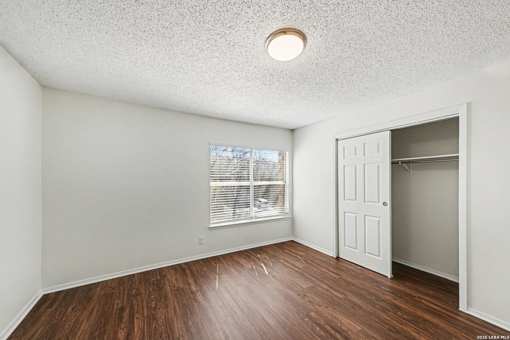 2407 Canyon Rim San Antonio, TX 78232 - Photo 22 of 30 an empty room with wooden floor and windows