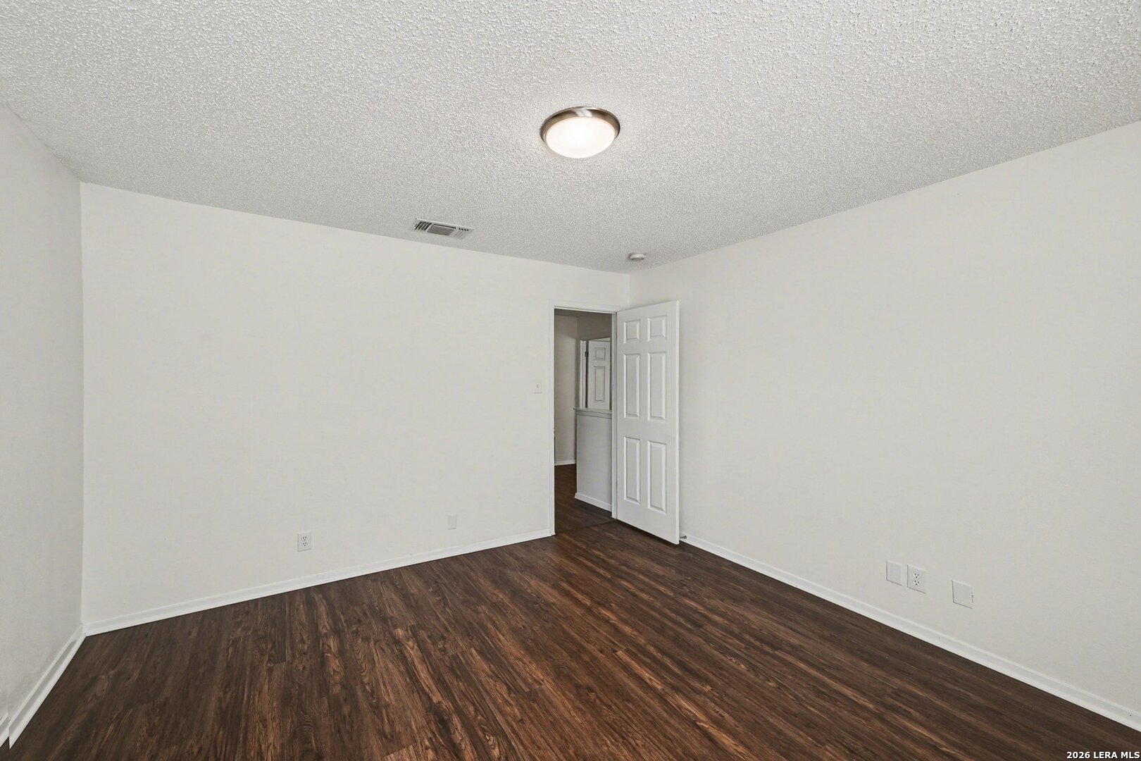 2407 Canyon Rim San Antonio, TX 78232 - Photo 23 of 30 a view of an empty room with wooden floor