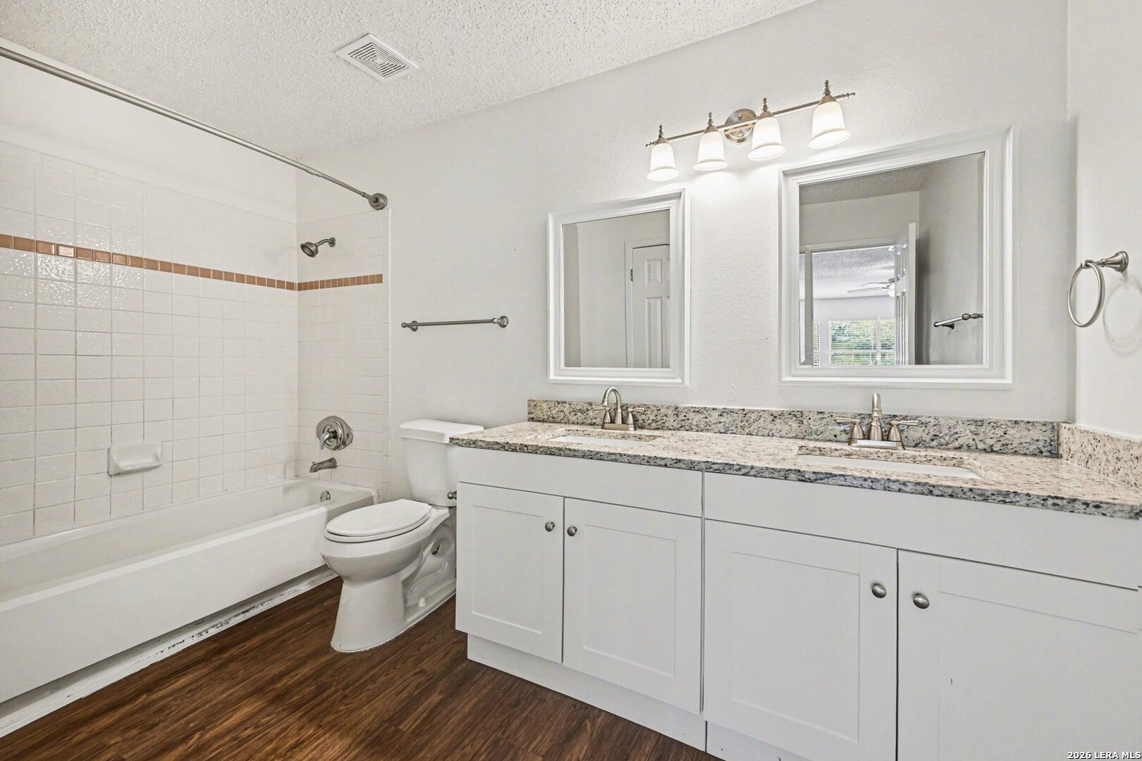 2407 Canyon Rim San Antonio, TX 78232 - Photo 24 of 30 a bathroom with a granite countertop toilet a sink and a mirror