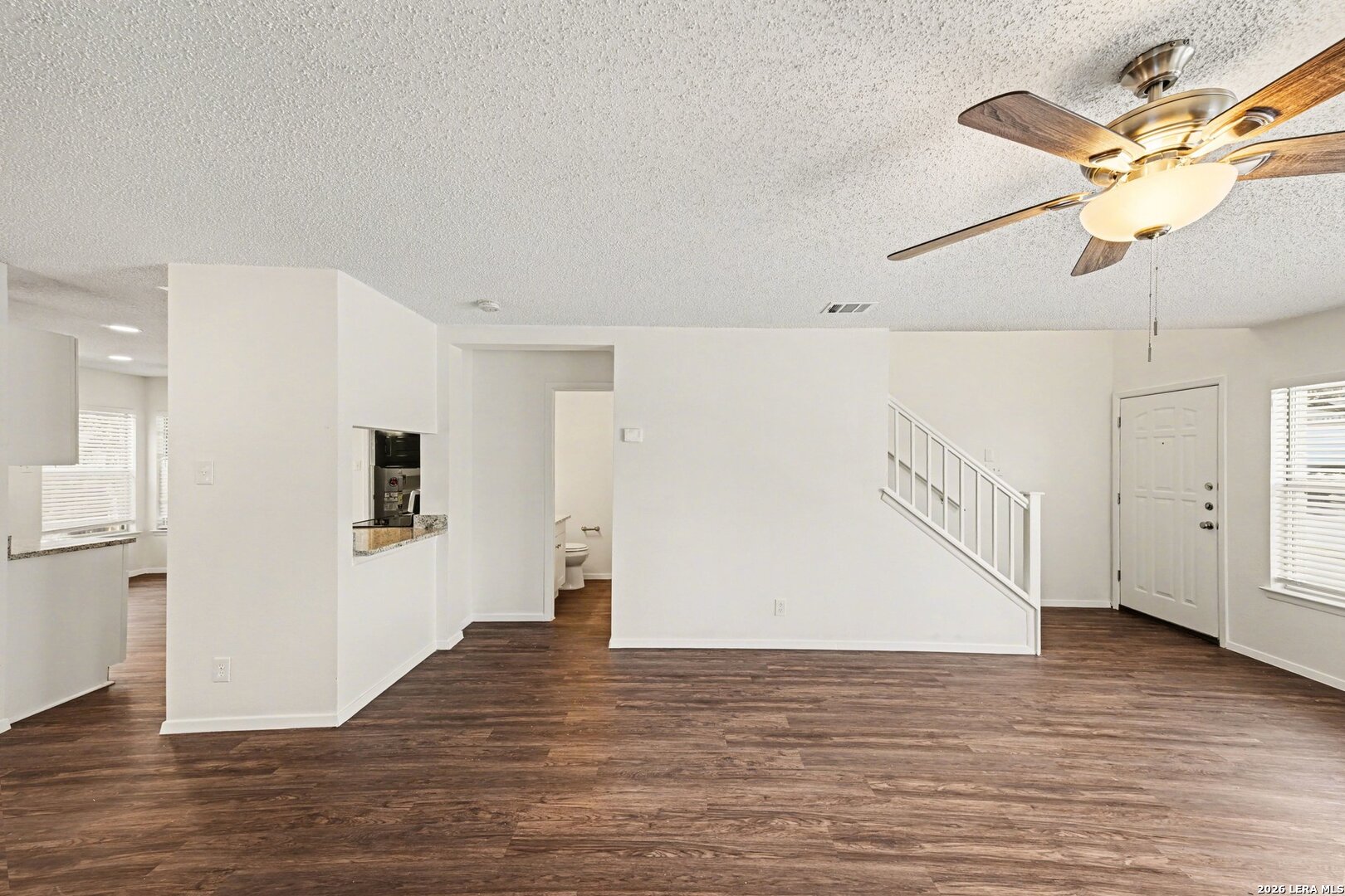 2407 Canyon Rim San Antonio, TX 78232 - Photo 6 of 30 a view of a livingroom with wooden floor and a ceiling fan