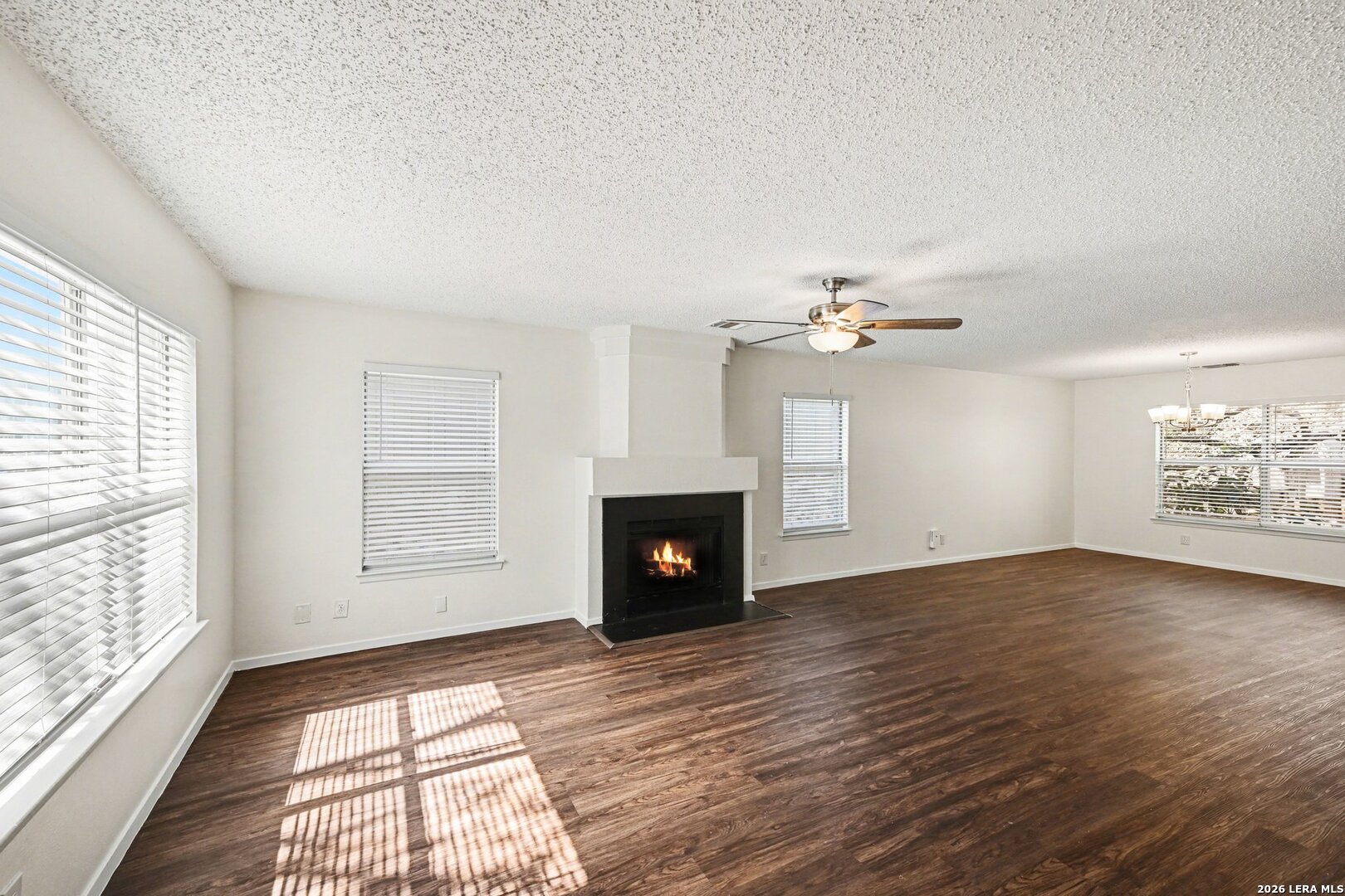 2407 Canyon Rim San Antonio, TX 78232 - Photo 7 of 30 an empty room with windows and fireplace