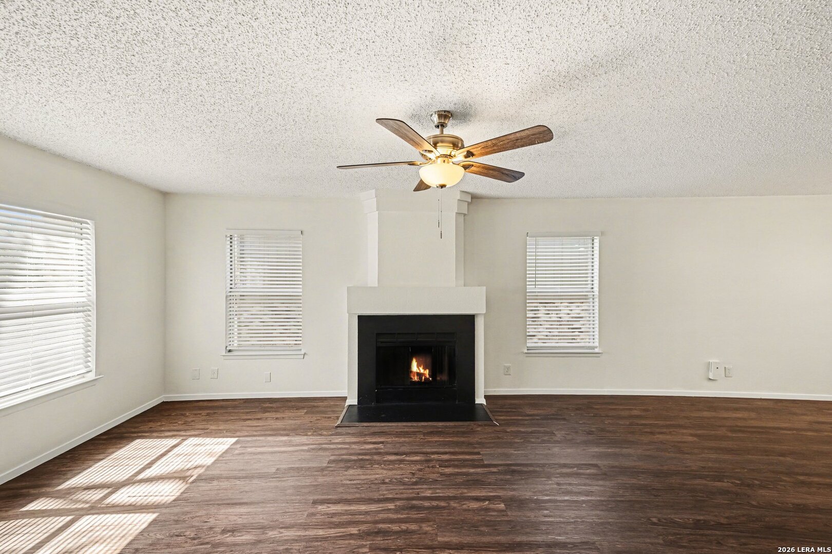 2407 Canyon Rim San Antonio, TX 78232 - Photo 8 of 30 a view of an empty room with wooden floor fireplace and a window