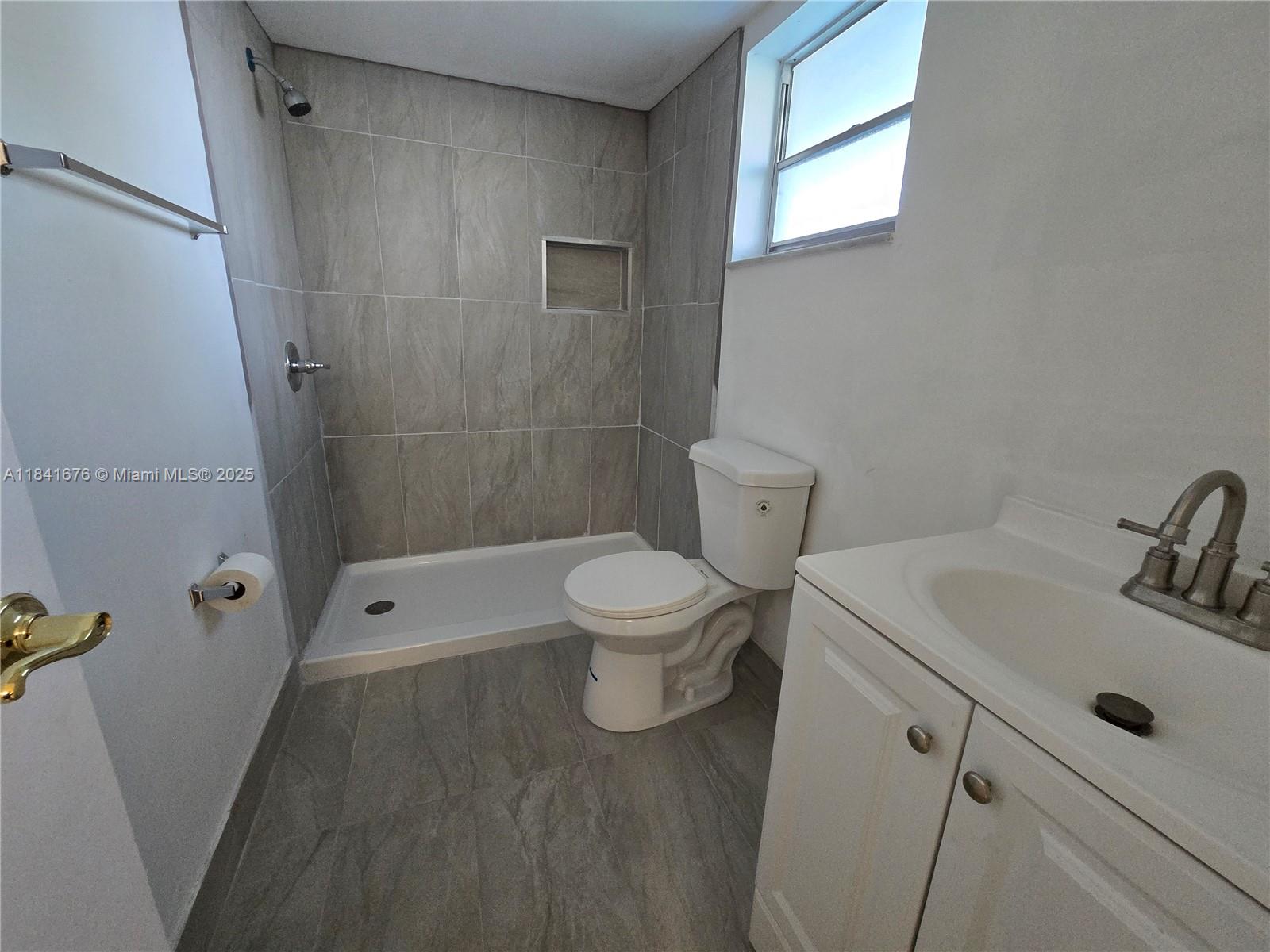 950 Hillcrest Drive, Unit 106 Hollywood, FL 33021 - Photo 15 of 30 a bathroom with a sink a toilet and shower
