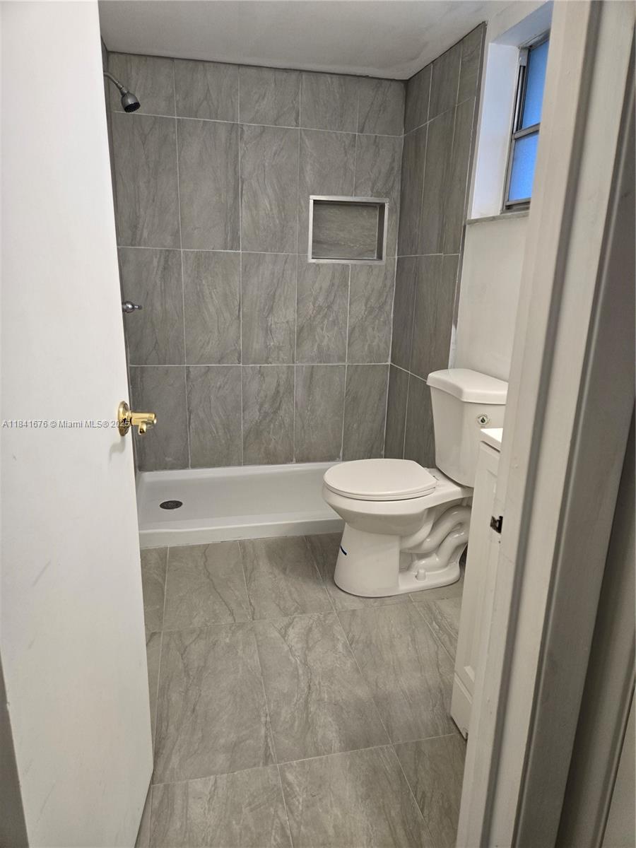 950 Hillcrest Drive, Unit 106 Hollywood, FL 33021 - Photo 16 of 30 a bathroom with a toilet and a shower