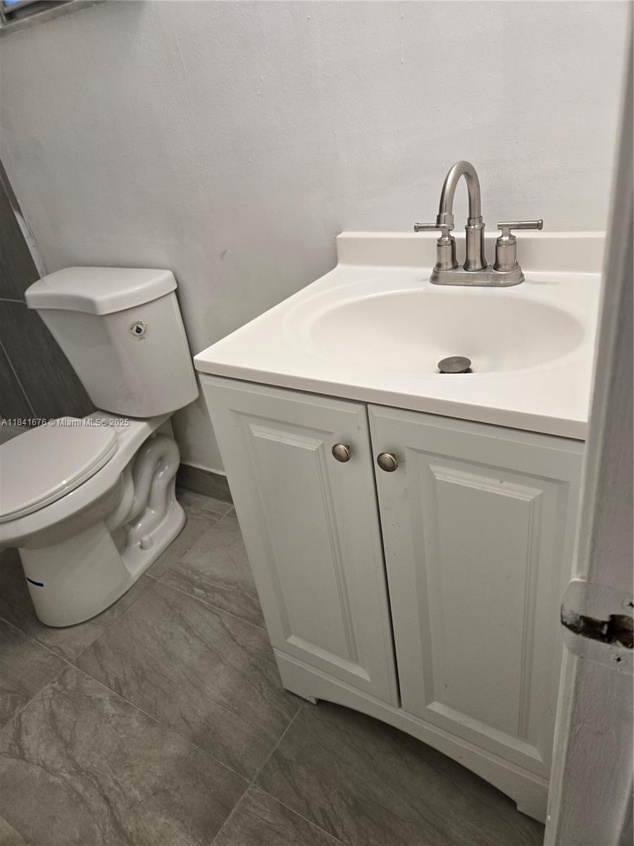 950 Hillcrest Drive, Unit 106 Hollywood, FL 33021 - Photo 17 of 30 a white toilet sitting next to a sink