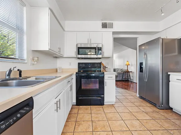 a kitchen with a sink a stove and refrigerator