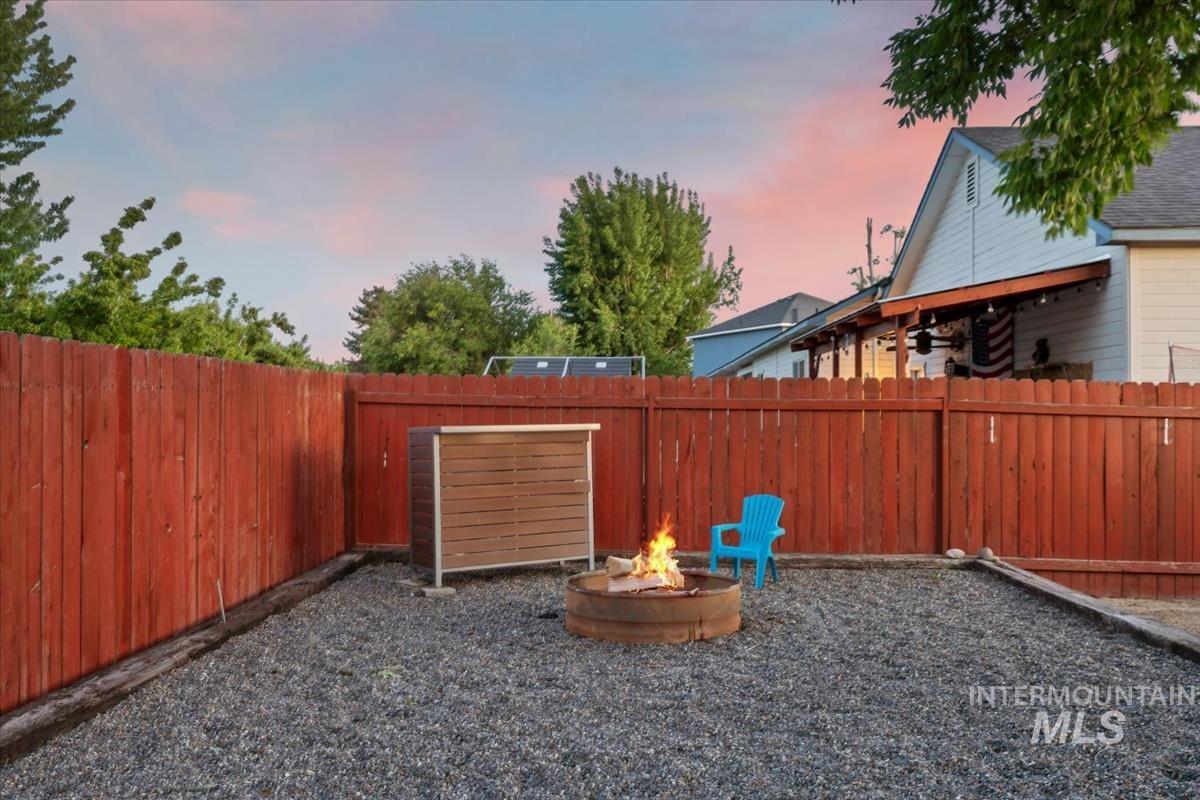 80 Cobblestone Court Middleton, ID 83644 - Photo 28 of 48 Expansive backyard featuring a gravel surface, wood privacy fencing, and a built-in fire pit