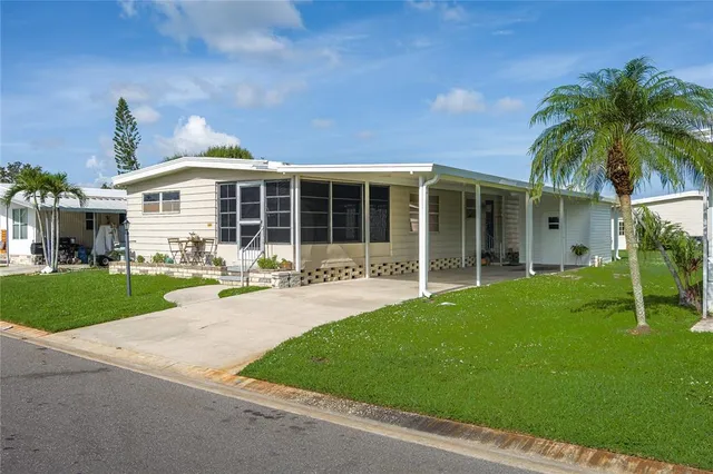 a front view of a house with yard and green space