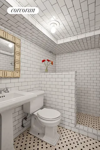 a bathroom with a toilet sink and shower