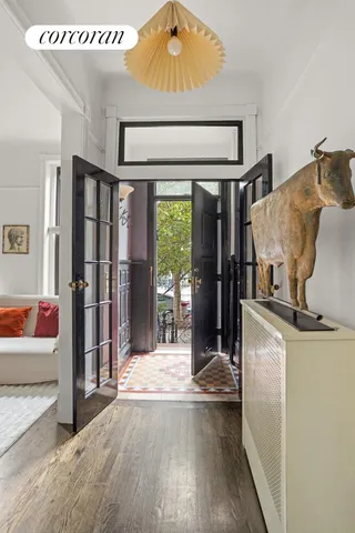 a view of an entryway with wooden floor and windows