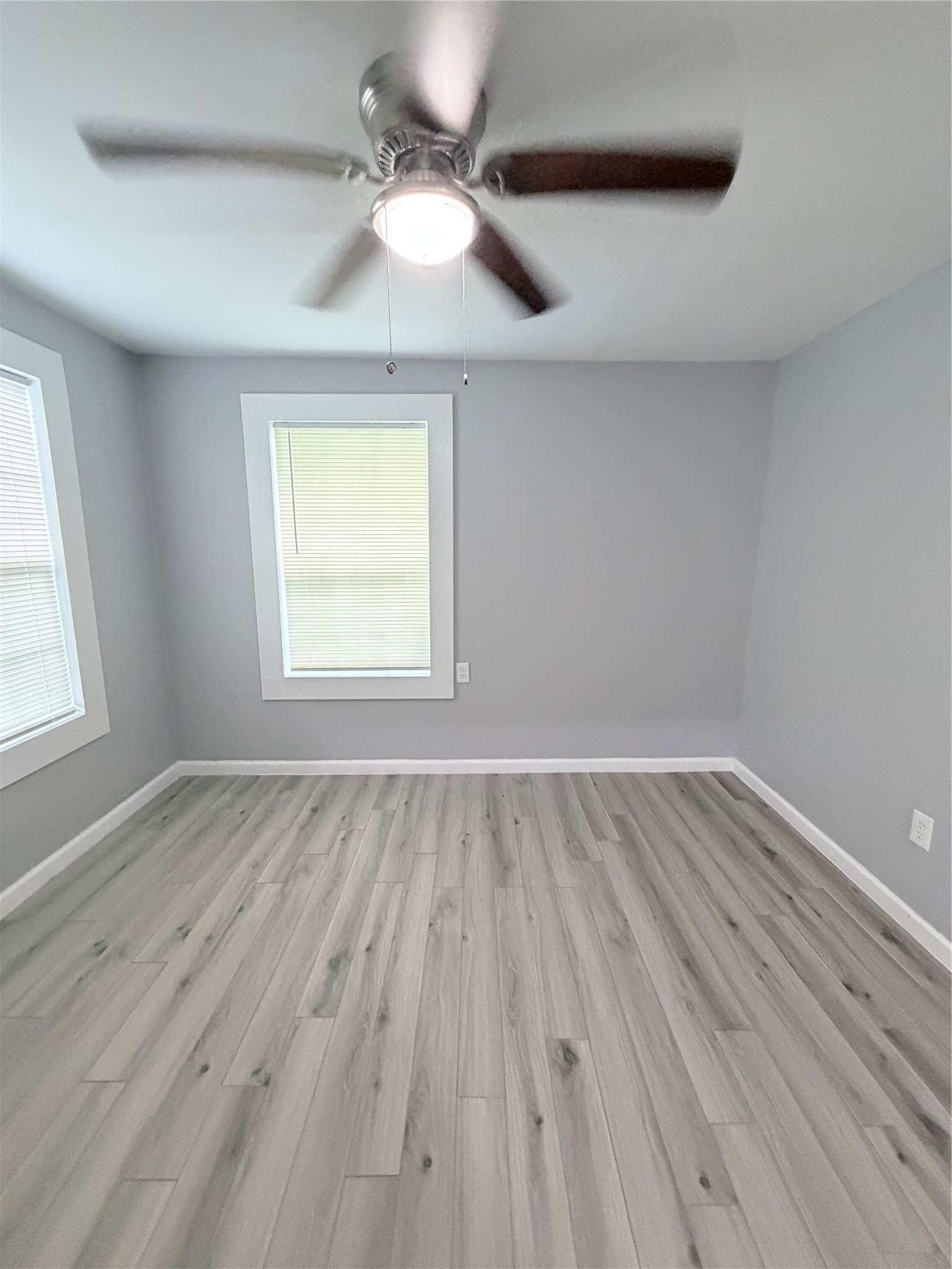 1903 Little Street La Marque, TX 77568 - Photo 13 of 18 wooden floor in an empty room with a window